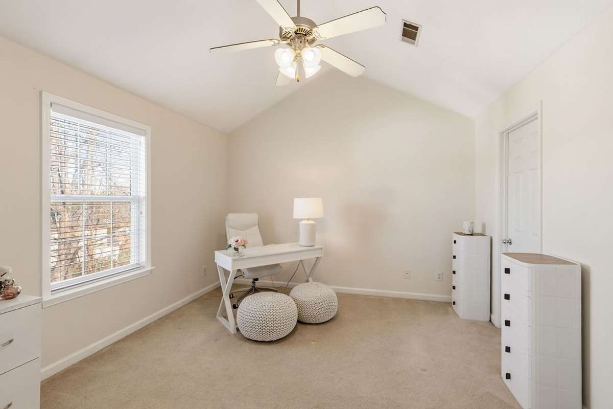 Primary bedroom with vaulted ceilings currently being used as an office.