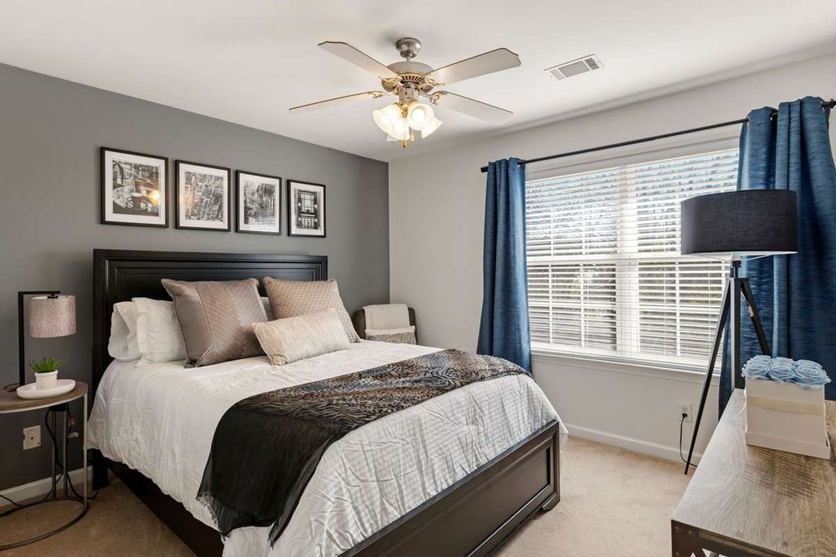 Secondary bedroom with Queen sized bed and still plenty of room for a dresser, nightstand and a chair in the corner.