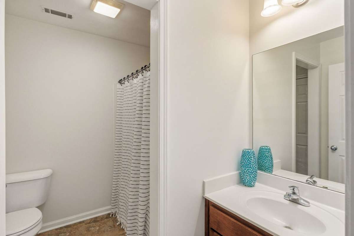 Full bath with separated vanity and tub and toilet room.