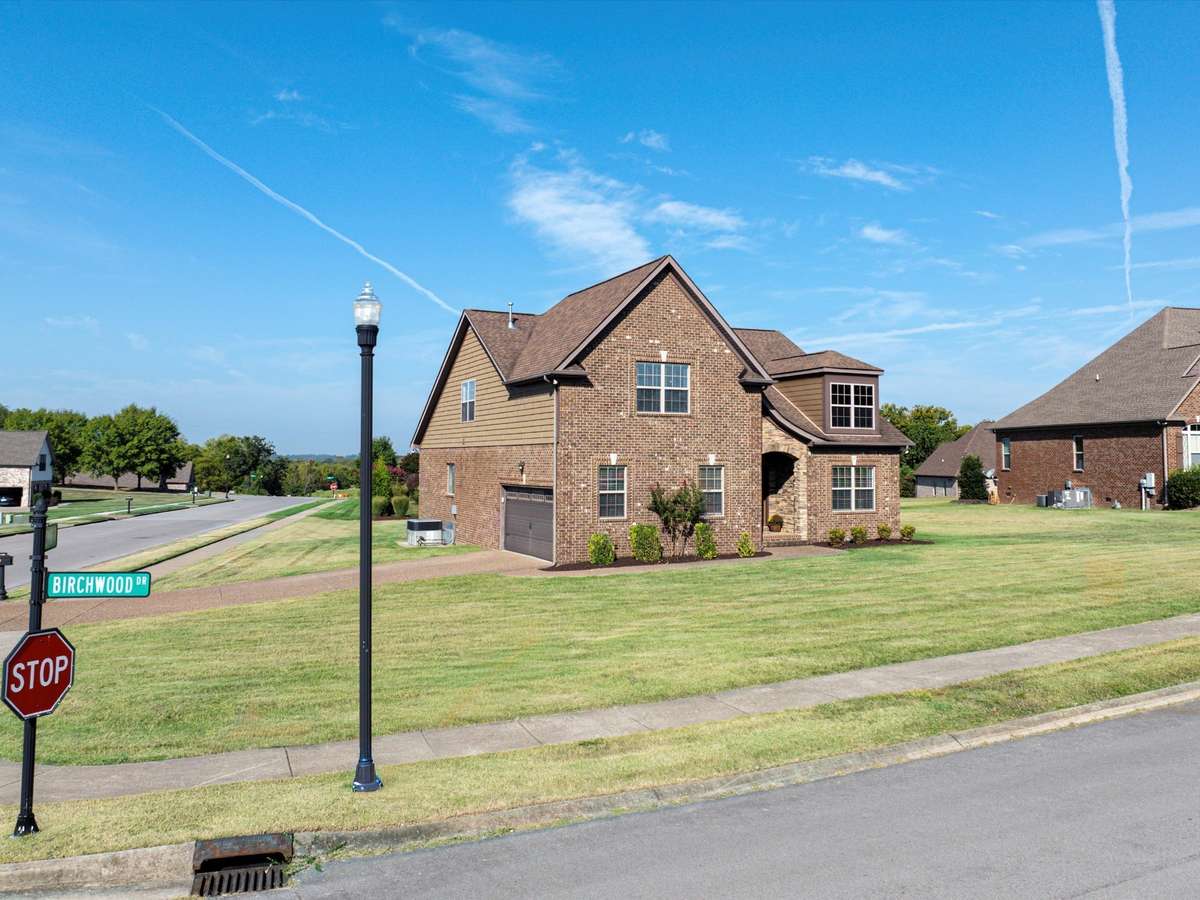 Two car attached side-entry garage with driveway space for up to 4 cars