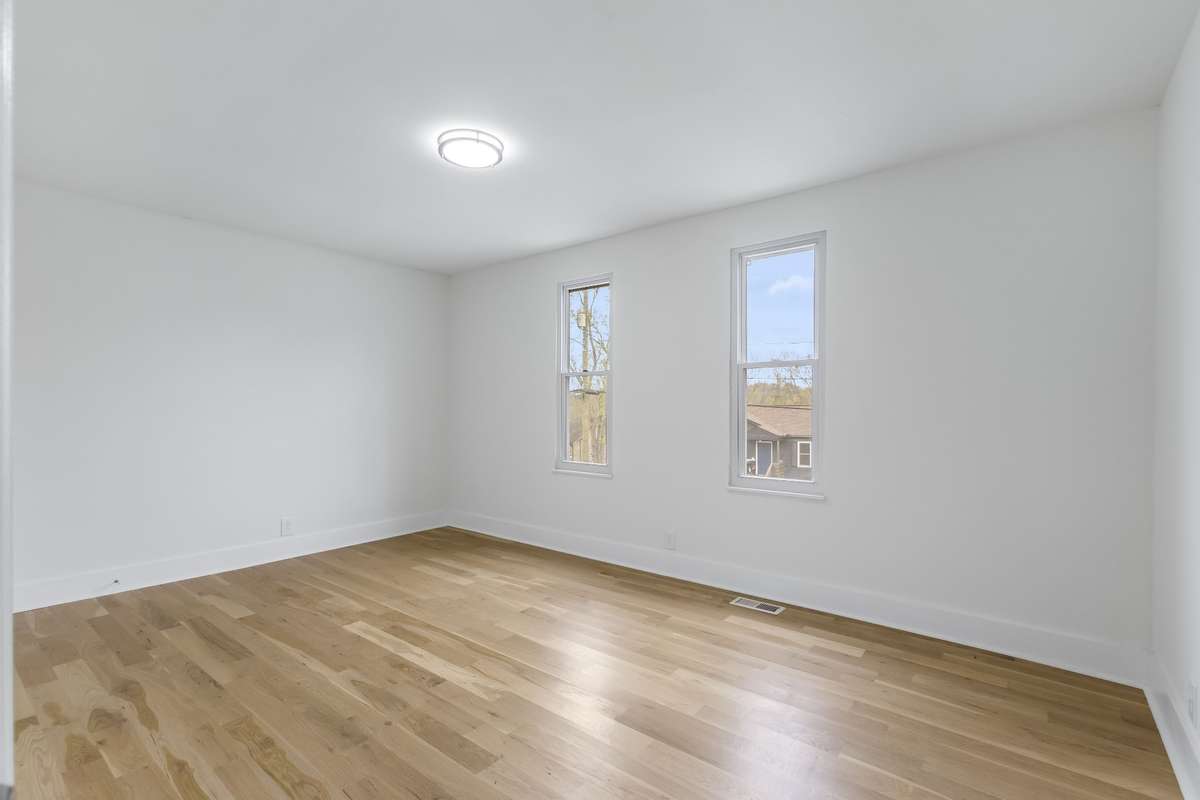 One of the home's three bedrooms with natural light and updated flooring.