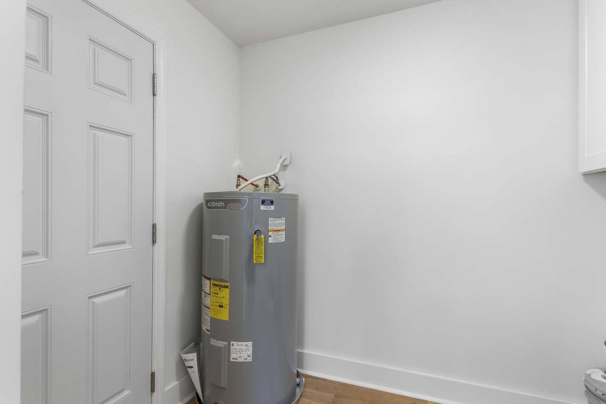 Mudroom area off kitchen w/ washer & dryer hookups and additional space for storage.