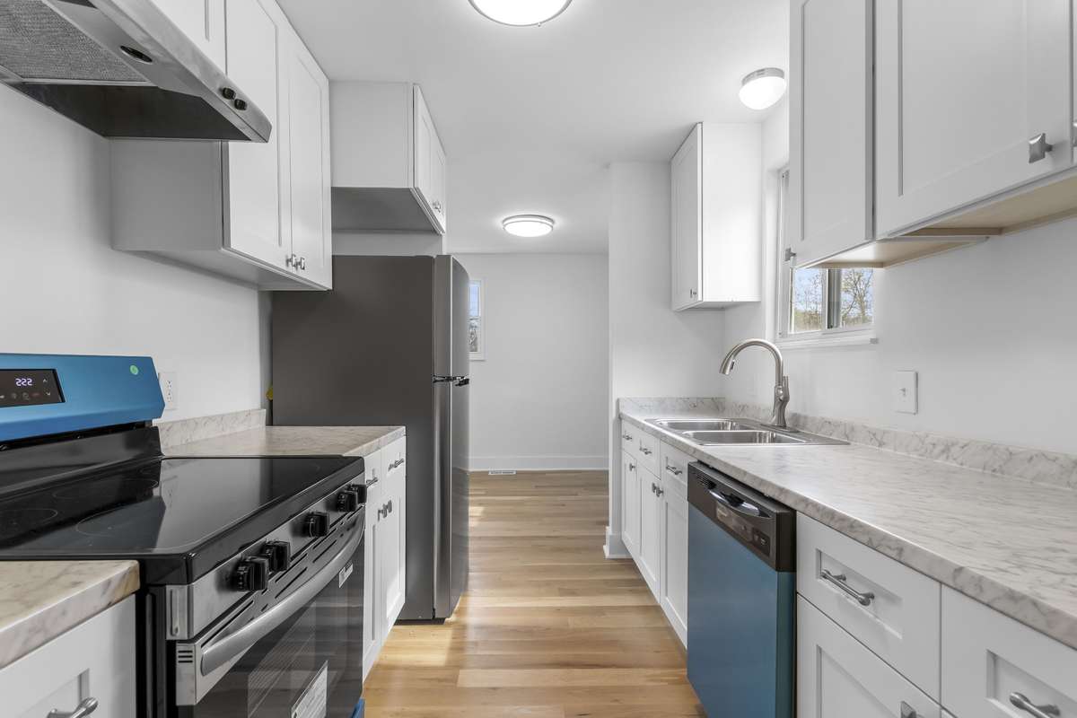 The kitchen offers efficient layout and plenty of cabinet storage.
