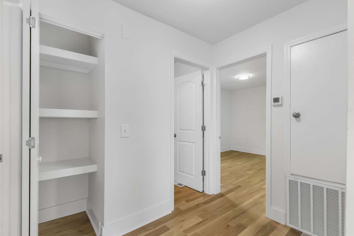 A view toward the hallway with built-in storage shelving.