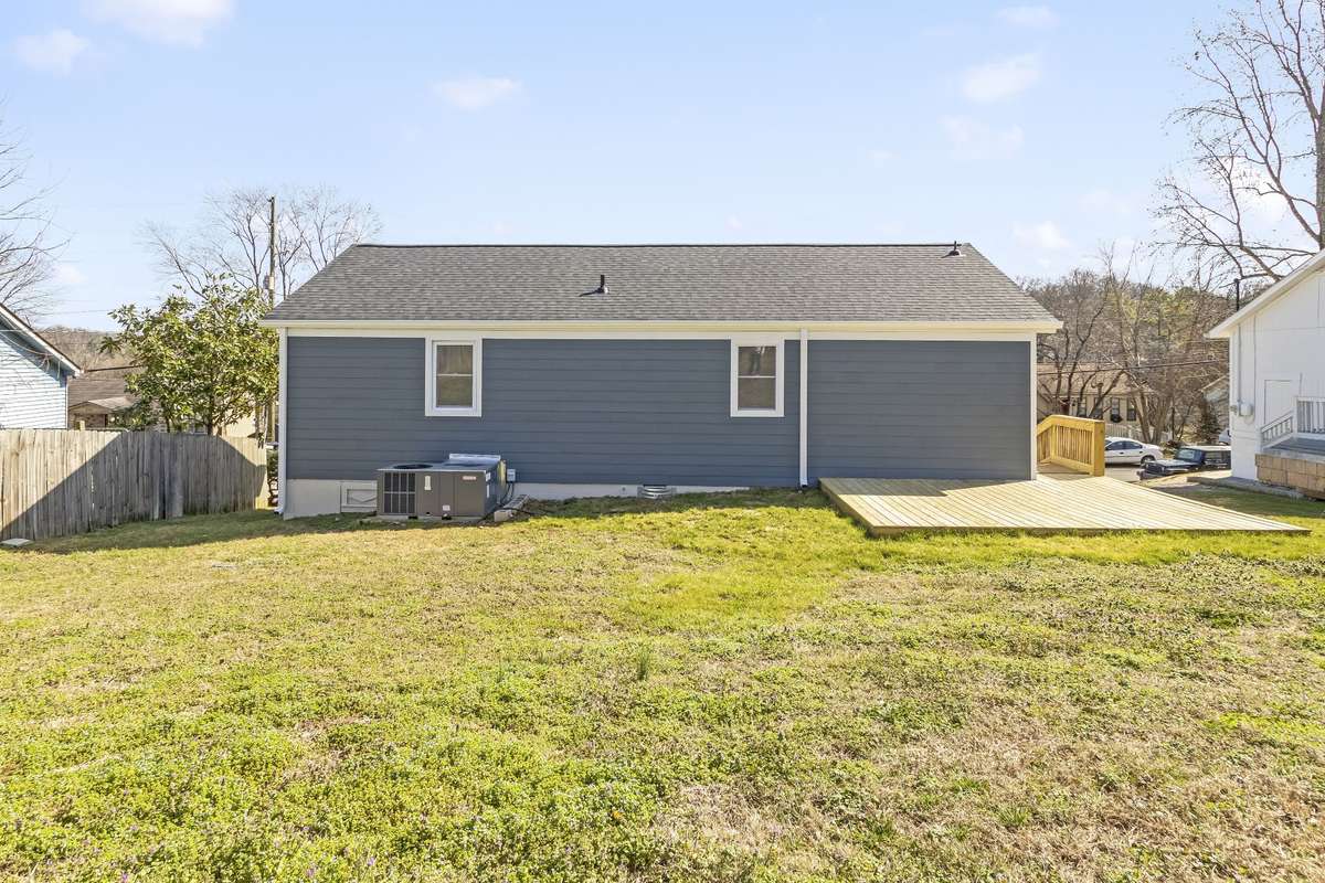 The backyard offers plenty of room for pets, play, or future landscaping.