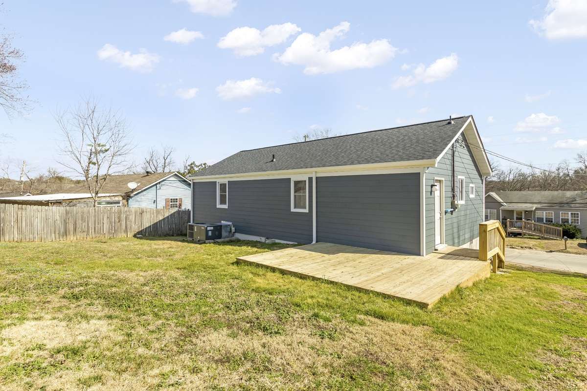 The backyard includes a spacious lot and a new deck for relaxing or entertaining.