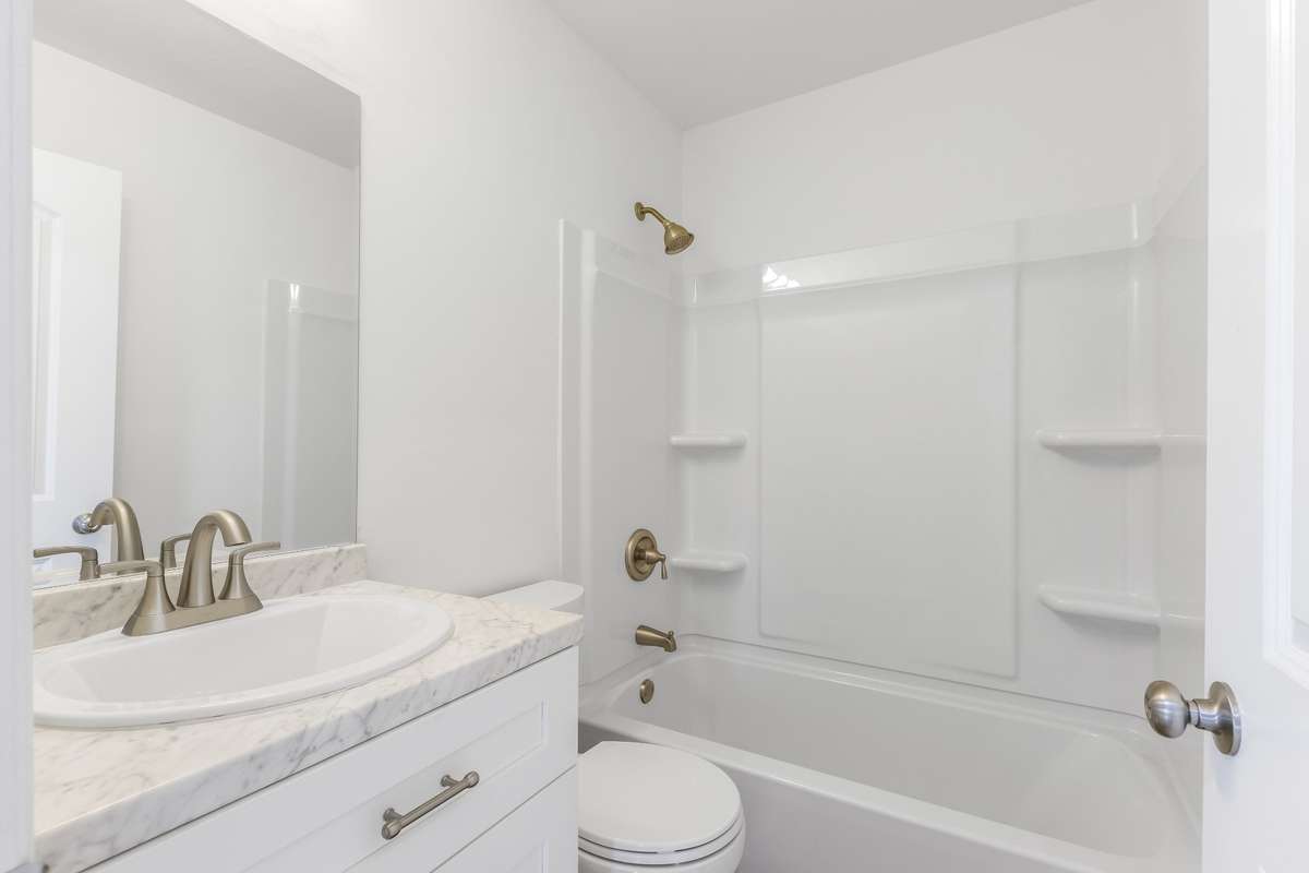 The renovated bathroom features a new vanity and updated fixtures.