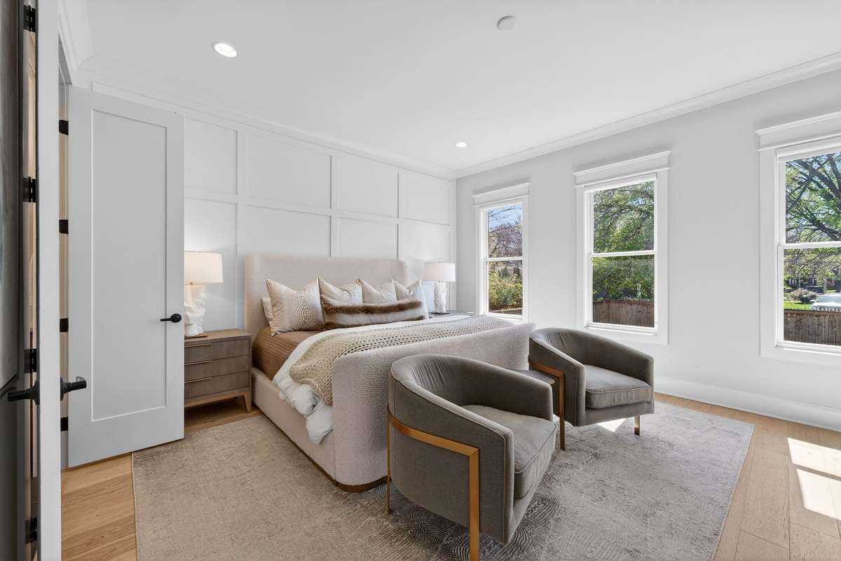 A light-filled primary retreat offering comfort, space, and elegant finishes.