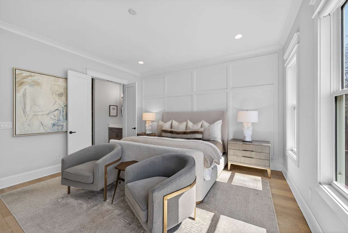 A spacious primary retreat with a cozy sitting area and refined finishes.