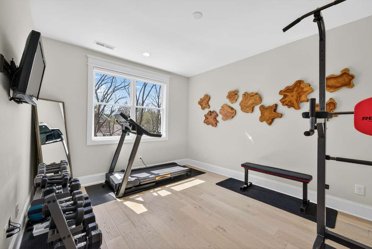 The fourth bedroom is currently styled as a private fitness space, offering both wellness and flexibility.