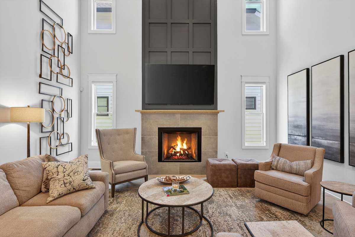 Soaring ceilings and a dramatic fireplace create a stunning focal point.
