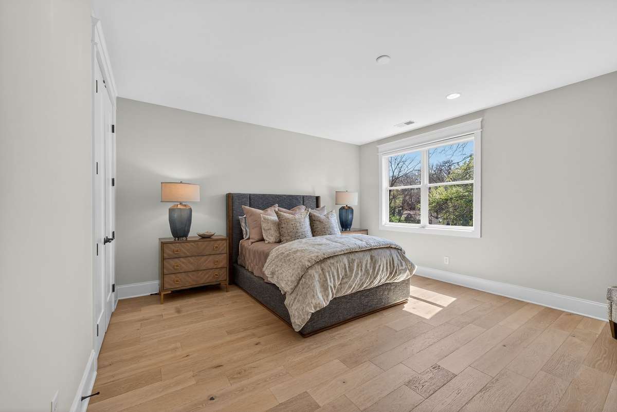 Another light-filled bedroom offering comfort and simplicity.
