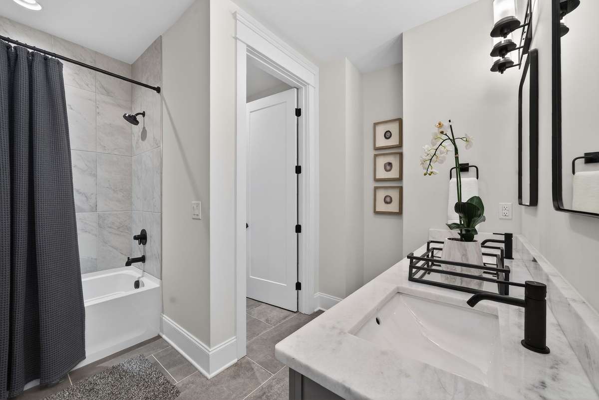 A clean and modern bath with elegant finishes throughout.