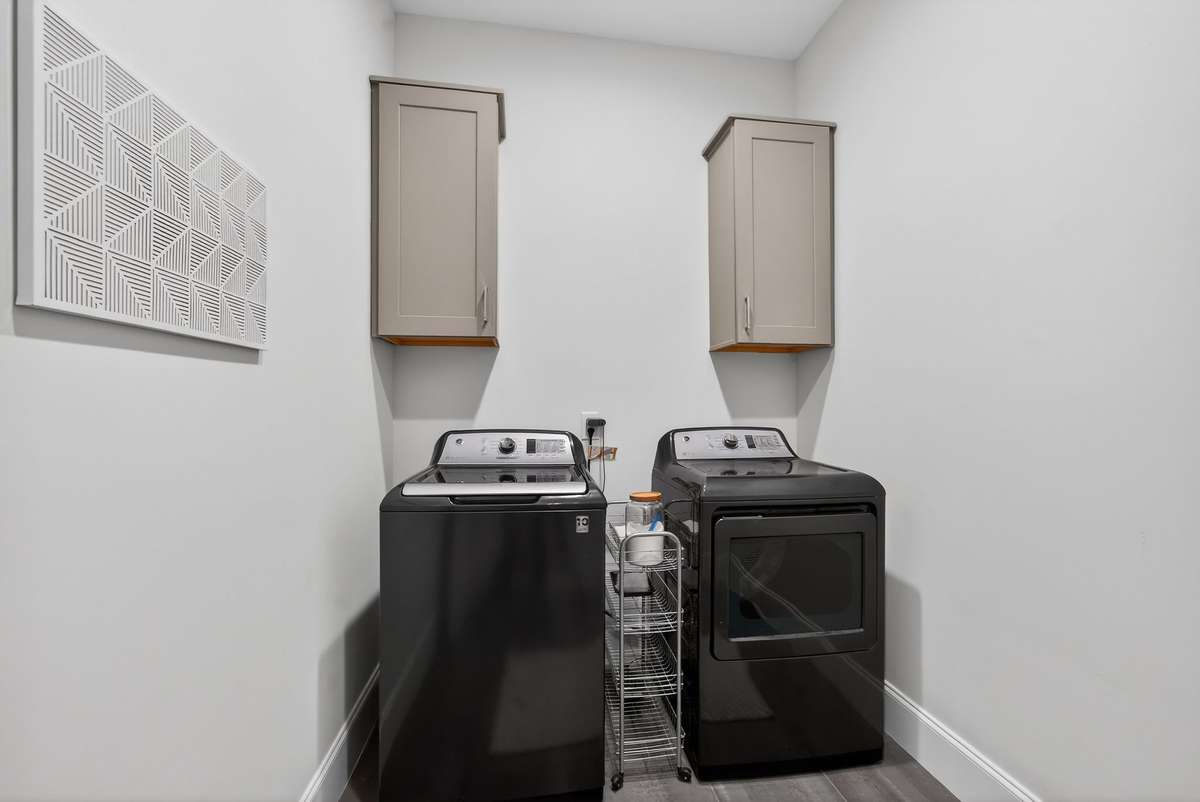 A sleek and functional laundry space designed for everyday convenience on the main floor.An additional upstairs laundry room complements the main-level laundry for added convenience.