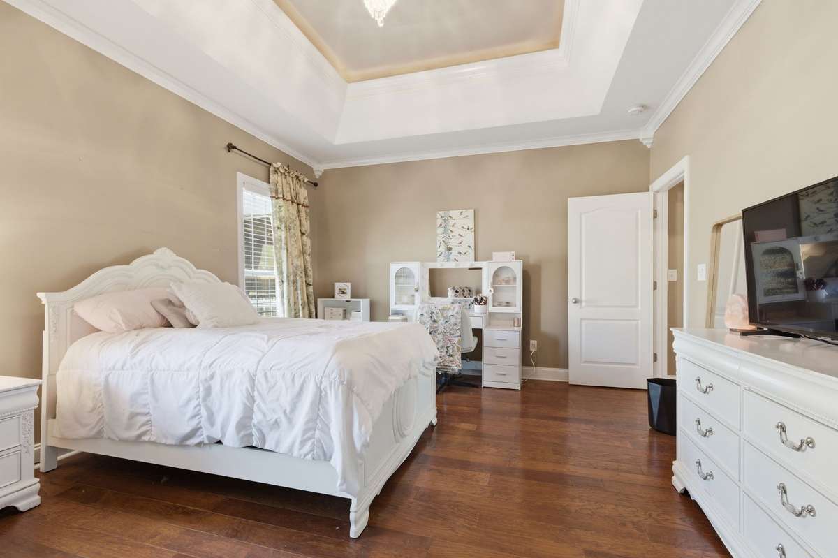 Beautiful hardwood flooring runs throughout the lower level, adding warmth and an upscale finish.