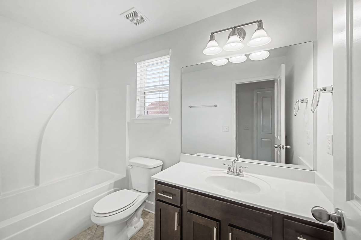 Crisp white paint and classic dark wood vanities will always be a classic.