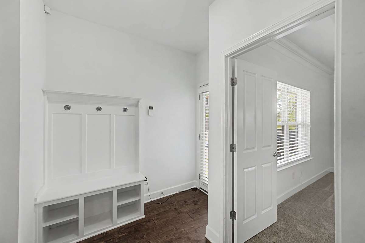 Custom drop station by the back door access to the garage is perfect for keeping everyone's things organized.