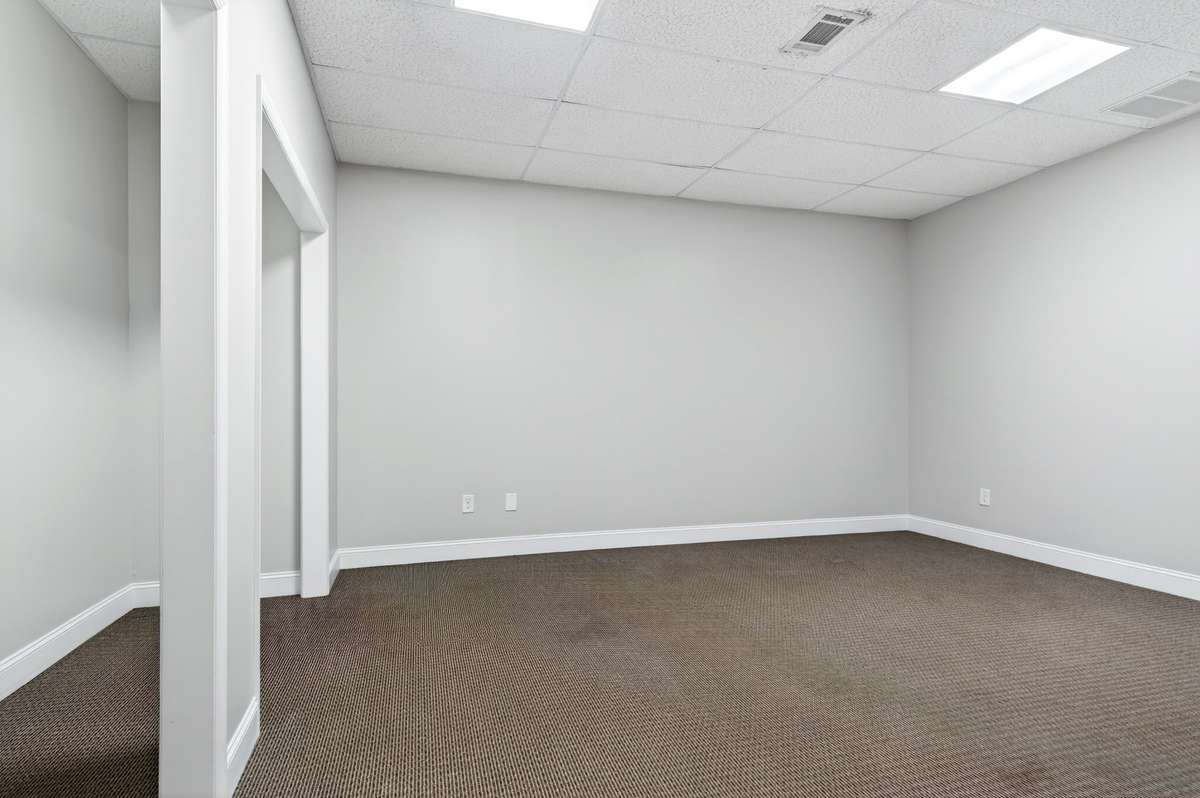 Finished basement area with closets and a full bathroom