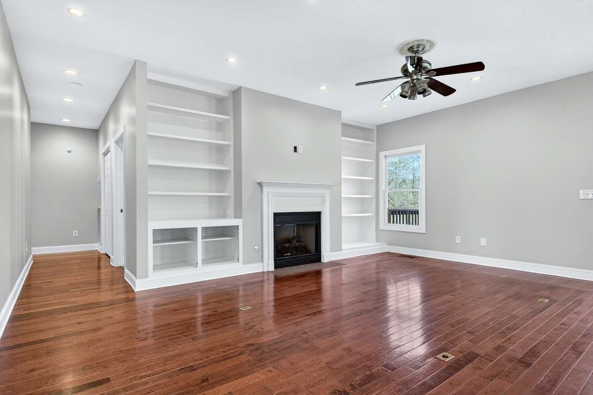 Beautifully open living room with gas fireplace and built-in shelving for all the pretties.