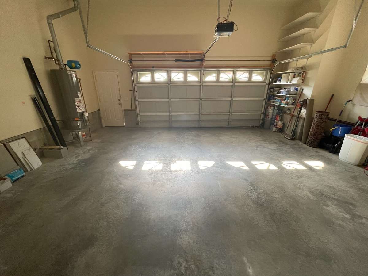 Shelves are ready for storage and Garage has passage door to driveway