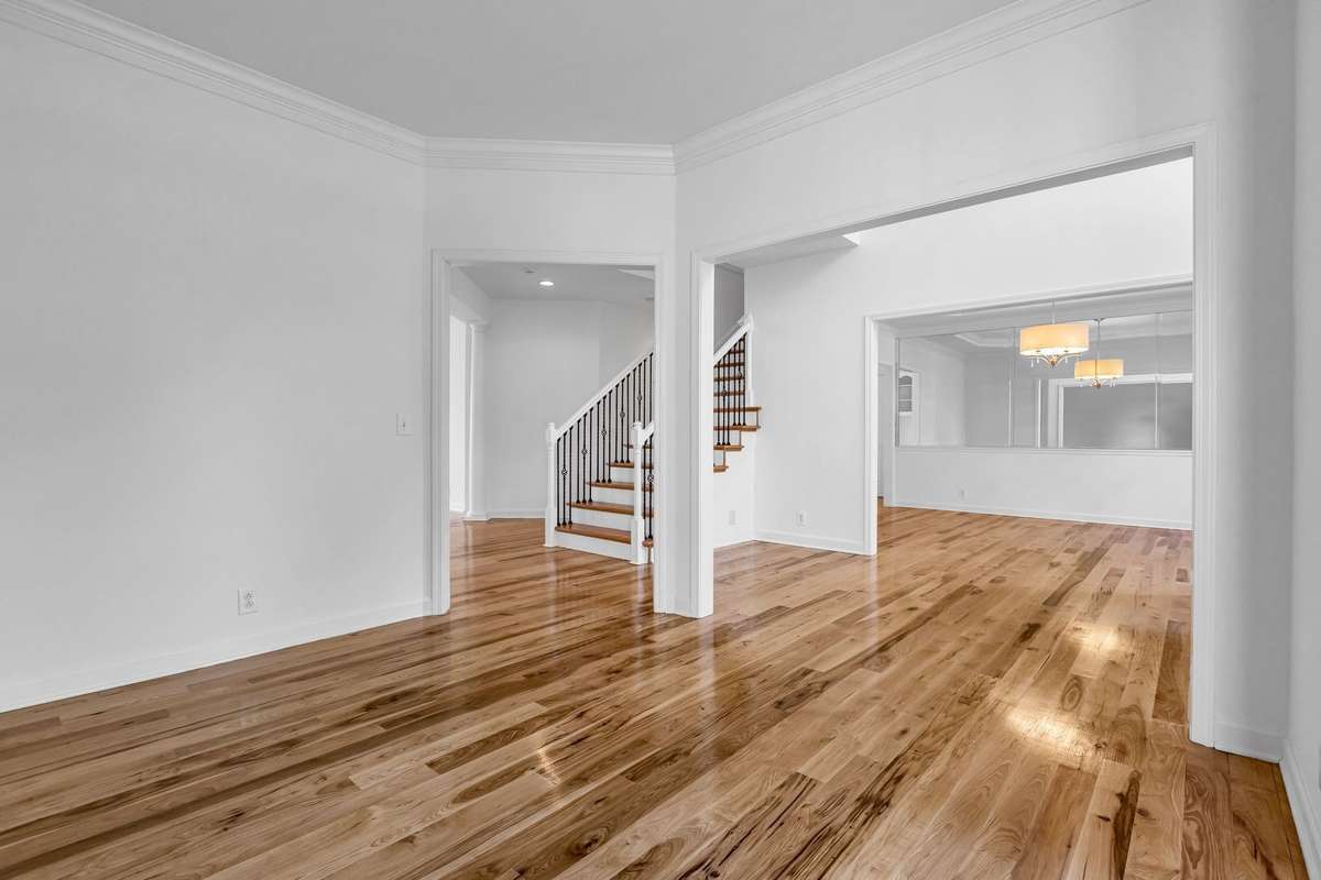 Living Room is open to entrance, hall, and den.
