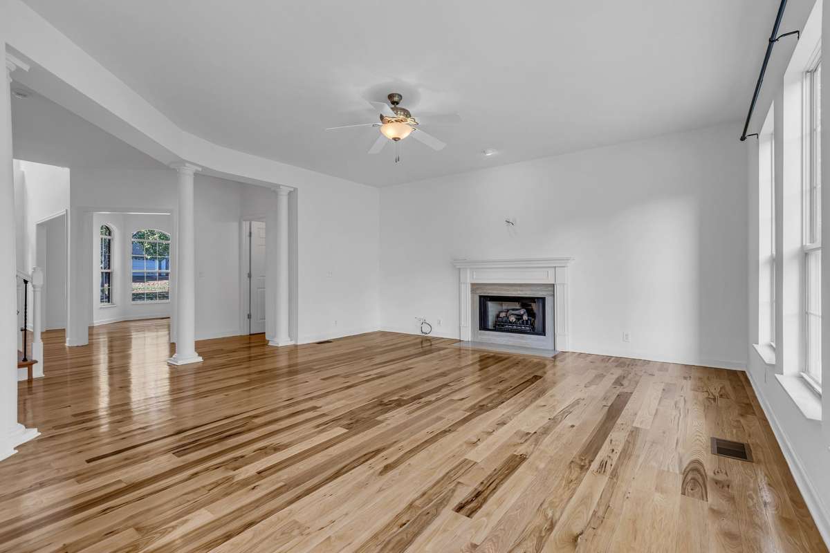 Den has columns to define openings to entrance and hall with access to 1/2 bath