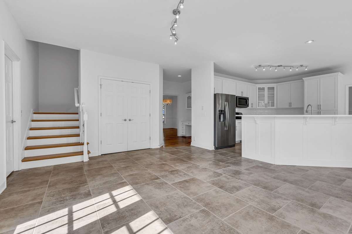Florida Room has secondary staircase, oversized pantry, and easy access to the garage, Dining Room and hall.