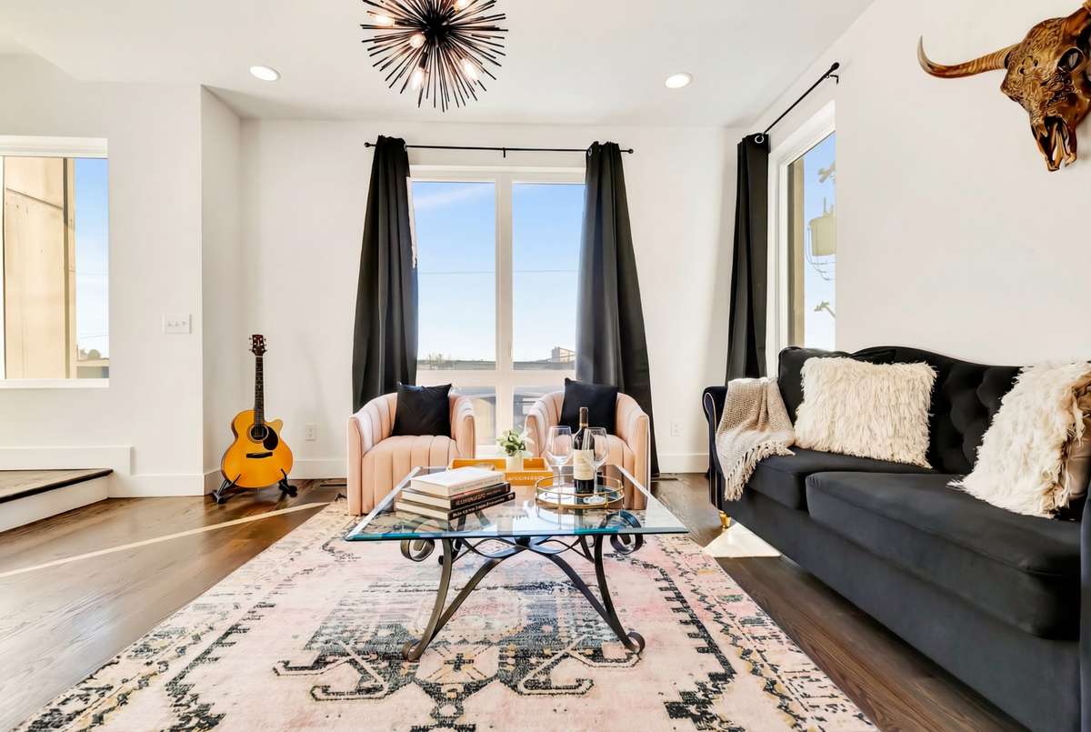 Tall windows fill the living room with natural light.