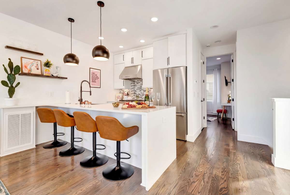 The kitchen features shaker cabinets and open shelving. A pantry provides additional storage space!