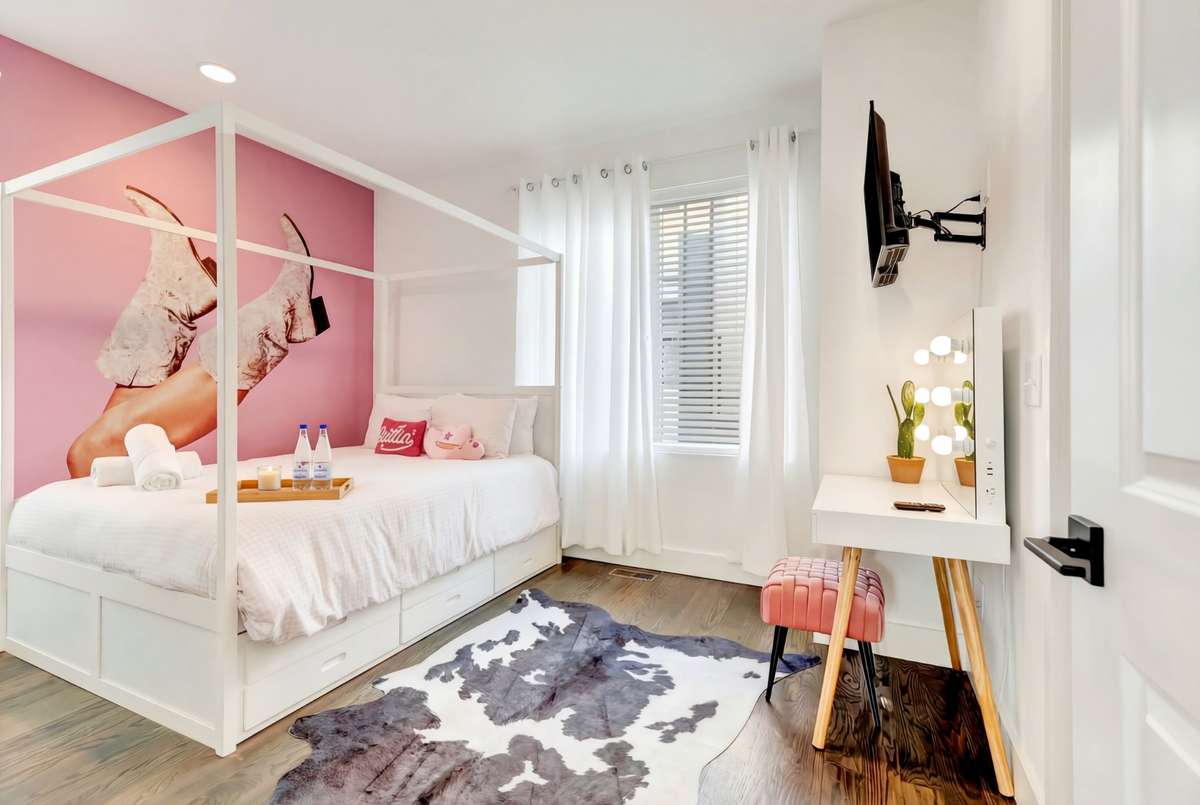 The third bedroom features a charming pink accent wall for a pop of color!