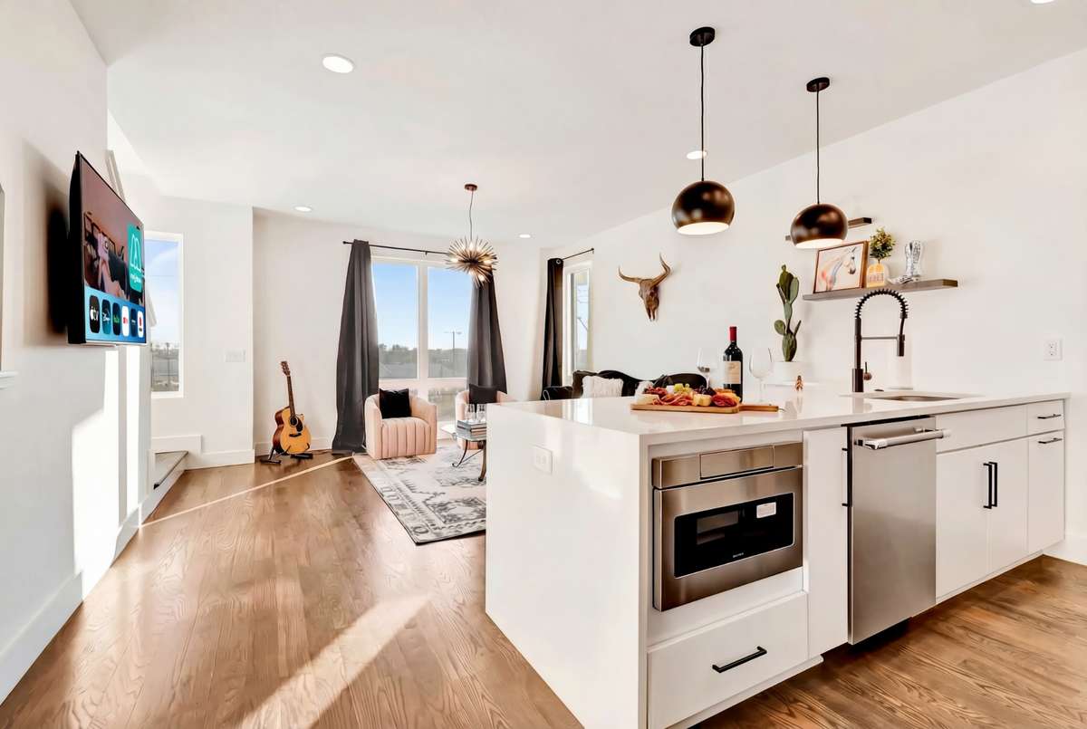 The main floor is a bright, welcoming space with warm hardwood floors.
