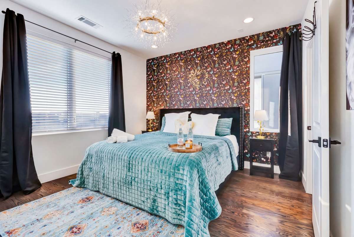 The primary bedroom has wide windows with incredible views of the city!
