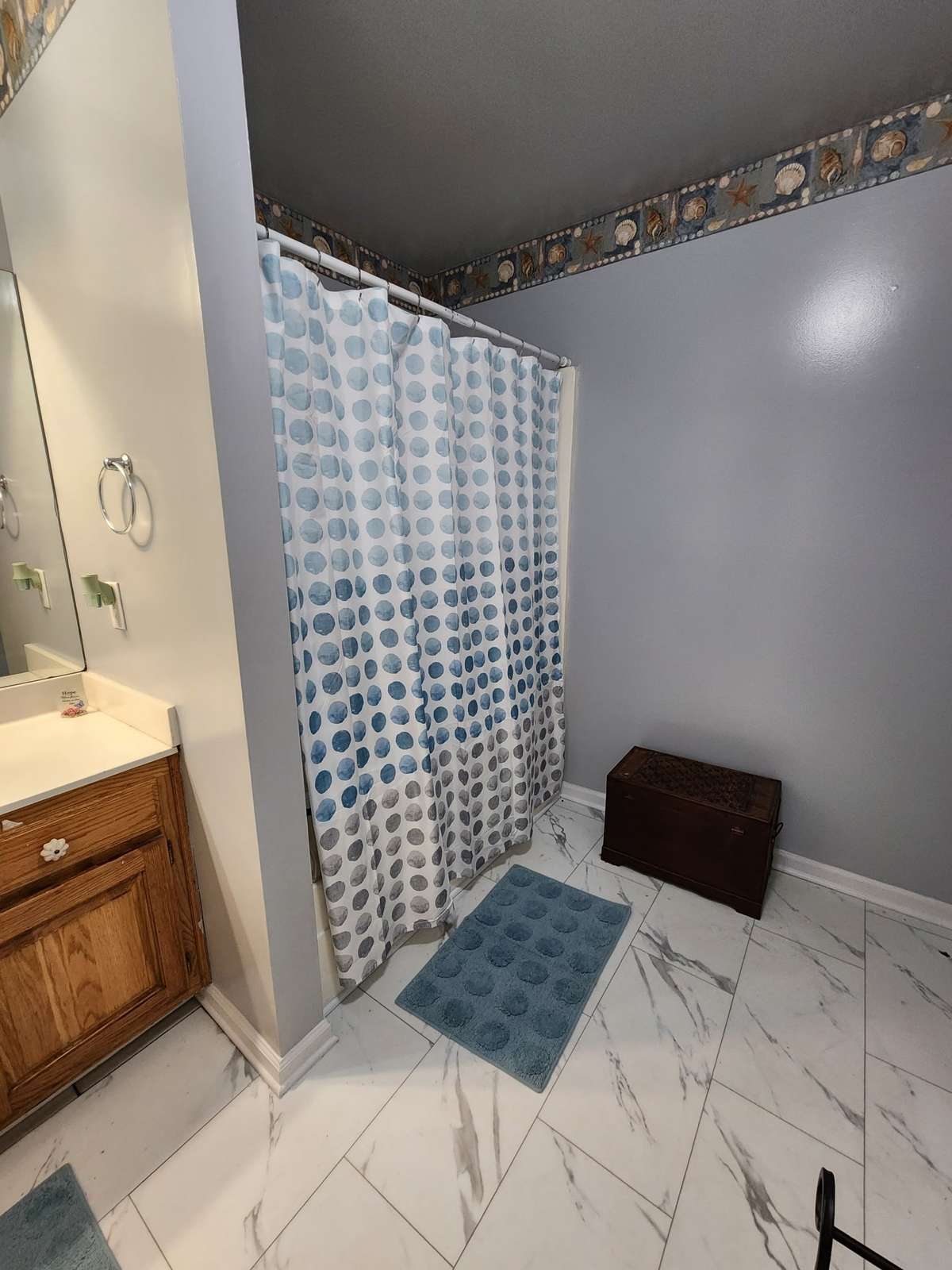 Spacious Hall bath with gorgeous tile floor and separate shower.