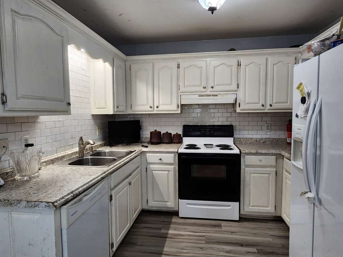 Kitchen has vinyl plank flooring and tons of cabinet space!