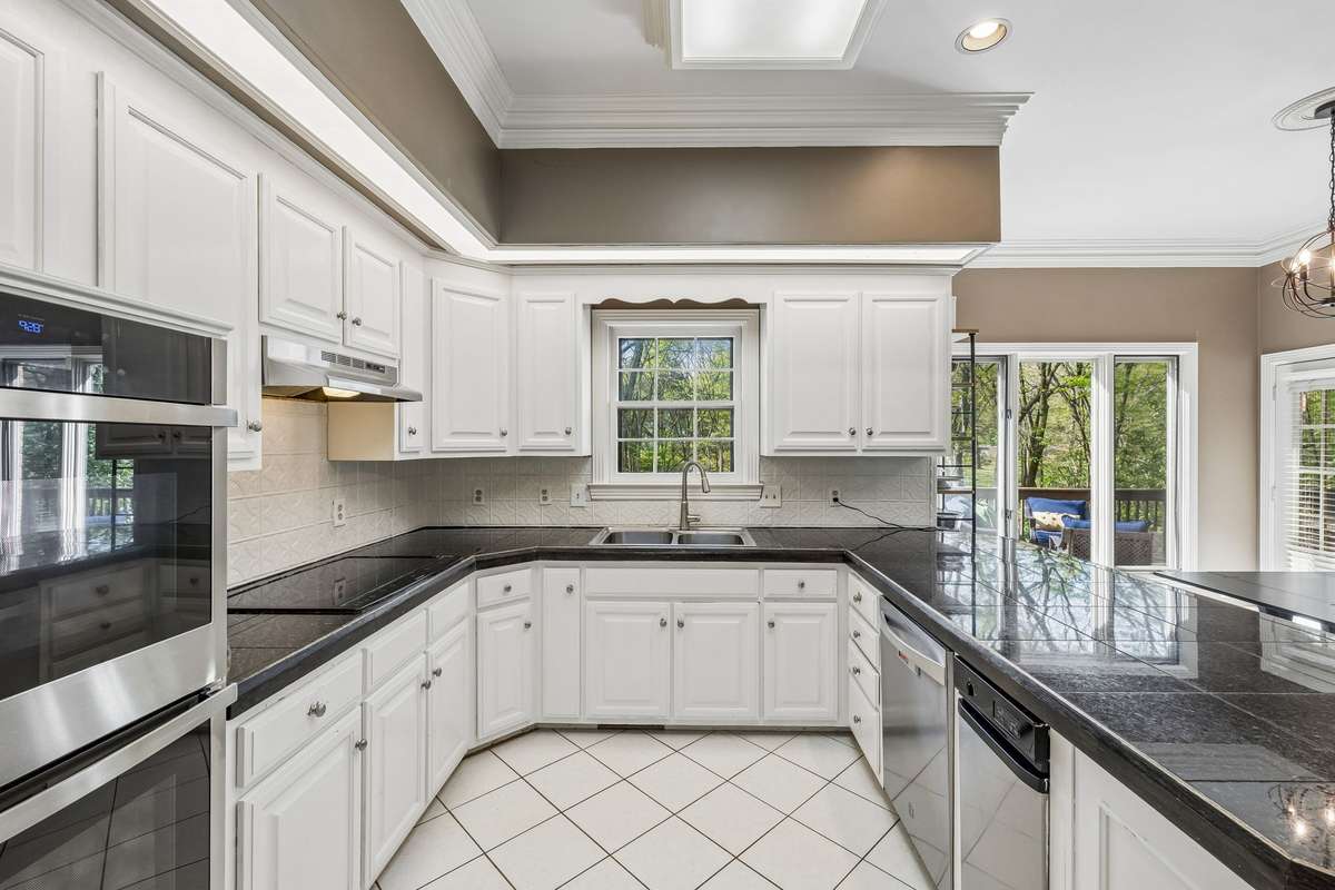 The window above the sink allows for a lovely view of the scenic backyard, making doing dishes less of a chore!