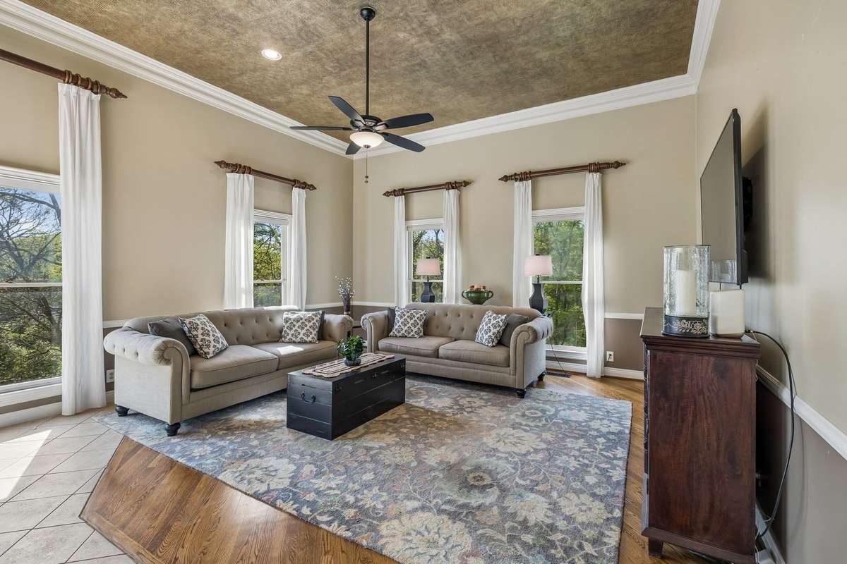 A first look at expansive main level bonus room above the garage. Three walls of windows, soaring ceilings and recessed lighting flood this space with an abundance of light ~ it will likely become your favorite room in the house!