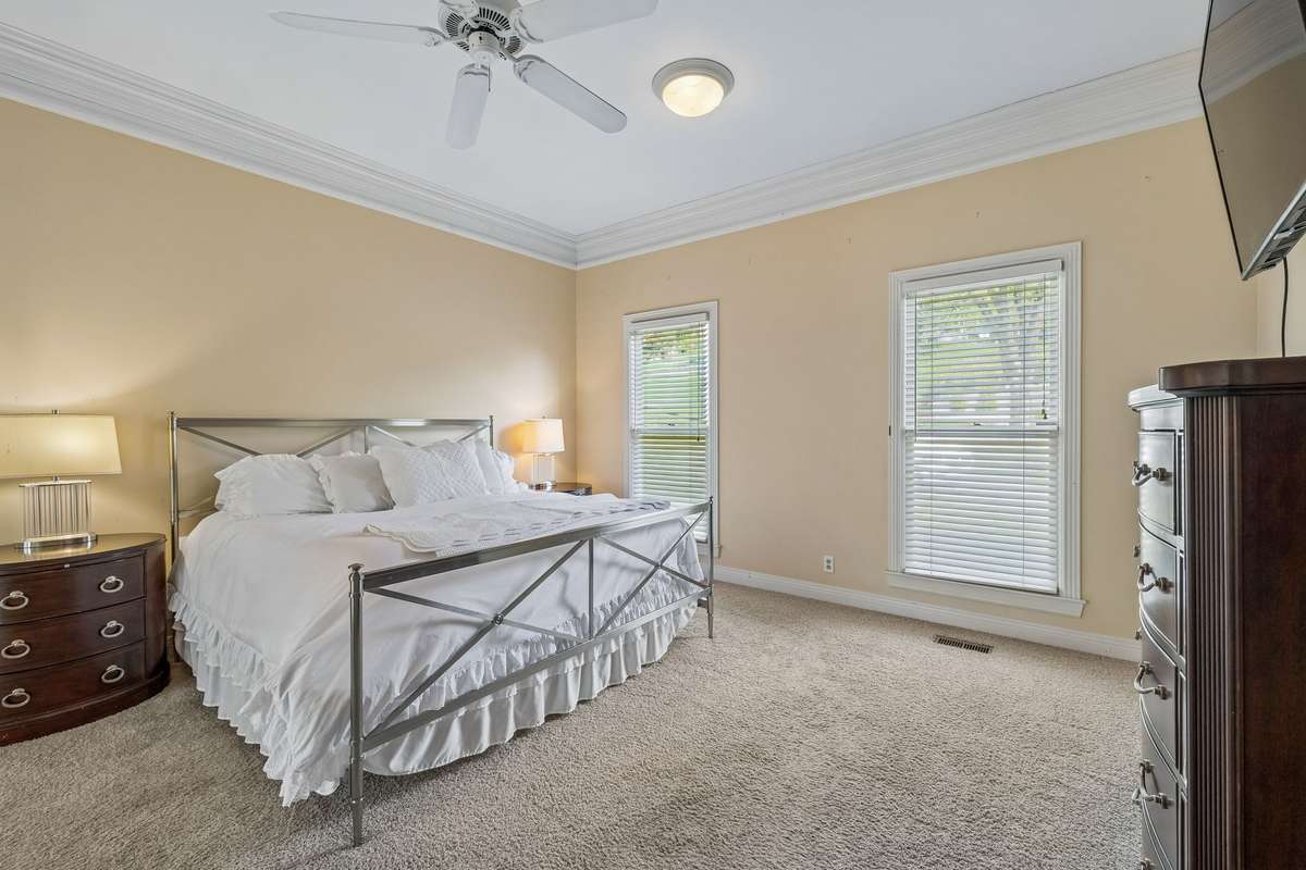 The primary bedroom overlooks both the front of the house as well as the back with the connected space.