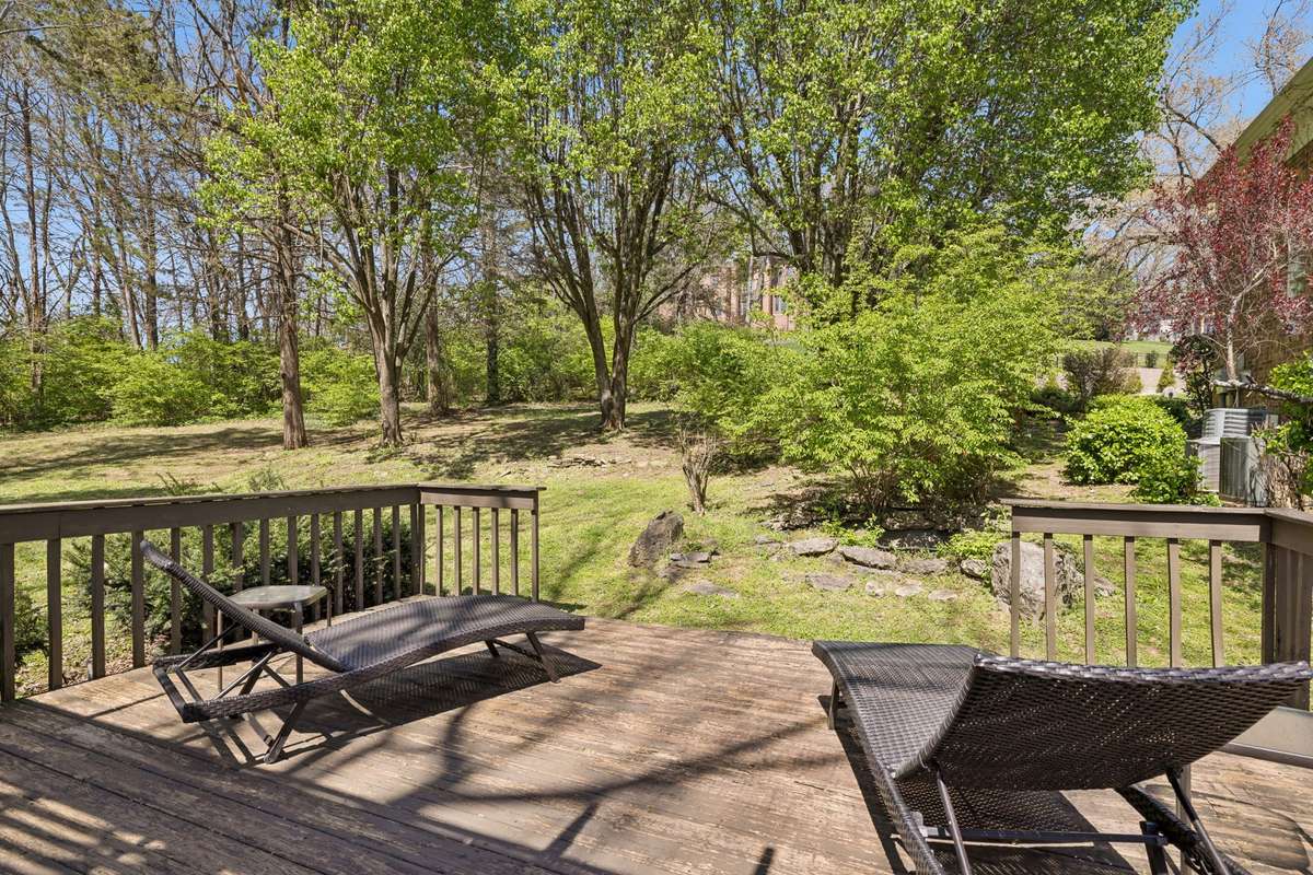 This lower deck level opens to the expansive side yard ~ so much space here and incredibly private!
