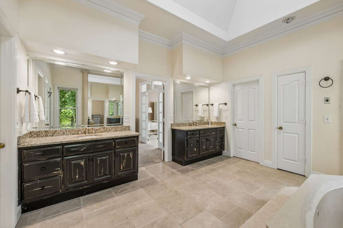The recessed lighting and skylight in this bathroom allow for a very bright and well lit space.
