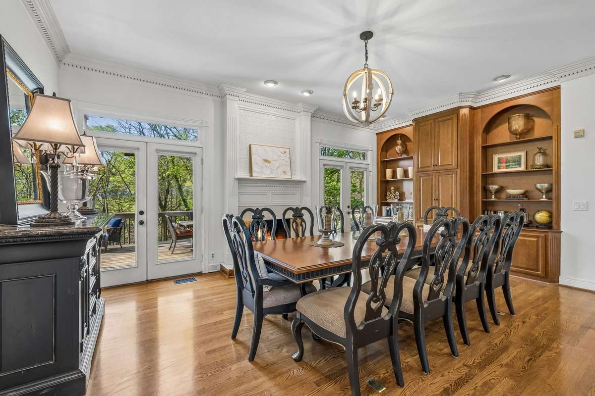 The built in cabinetry on the far wall is beautifully appointed and this room has two sets of doors that open to the outdoor deck.  The fireplace on the far wall anchors this space ~ this large area could also be used as a comfortable family room.