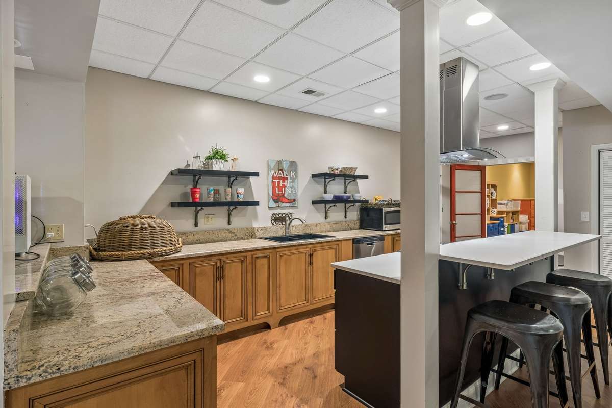 What an ideal setting for an inlaw or guest suite ~ this lower level includes a second laundry hookup, a full bathroom and nice sized bedroom with walk in closet, and access to the lower level patio and tree canopied backyard.