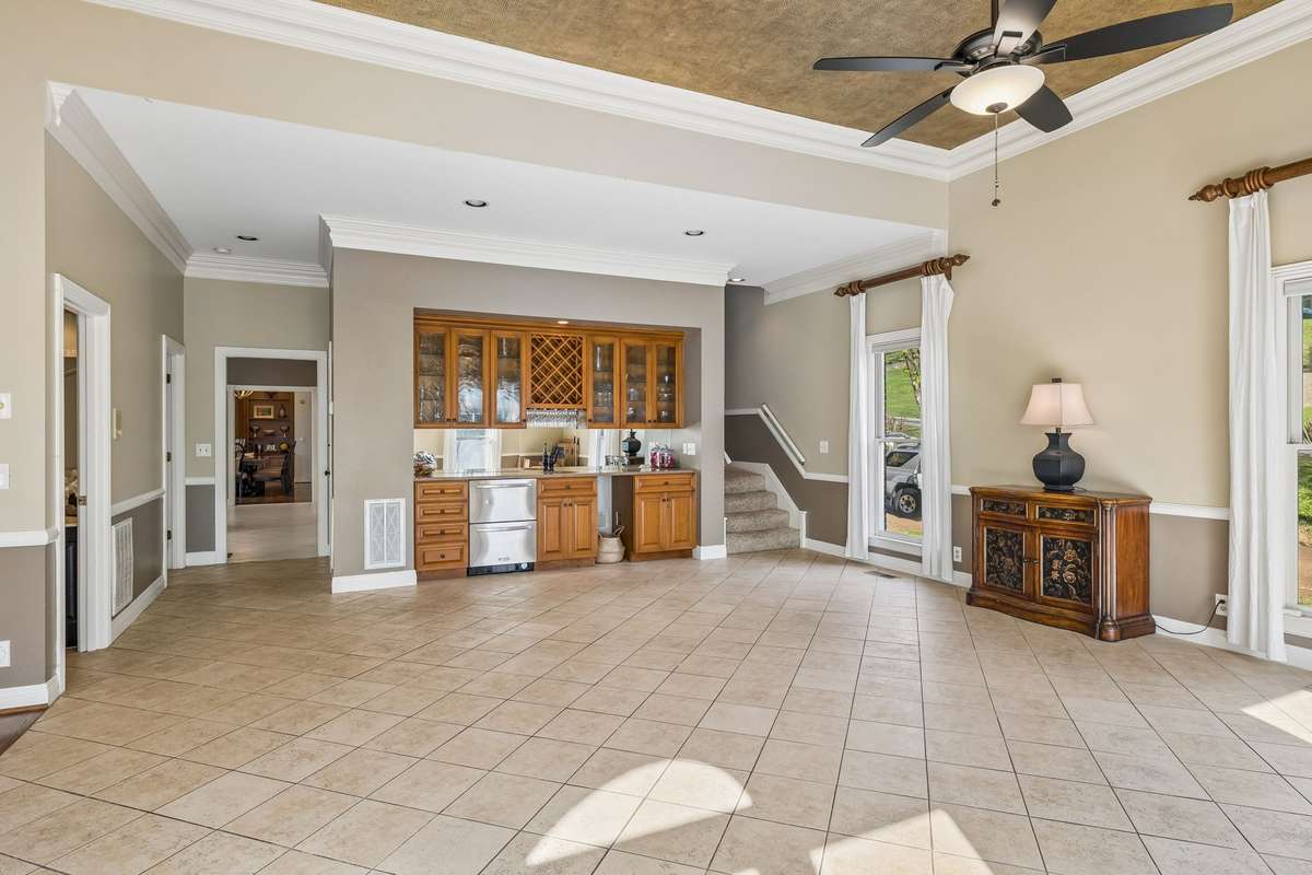 The back staircase in the far corner is one of two staircases leading upstairs.