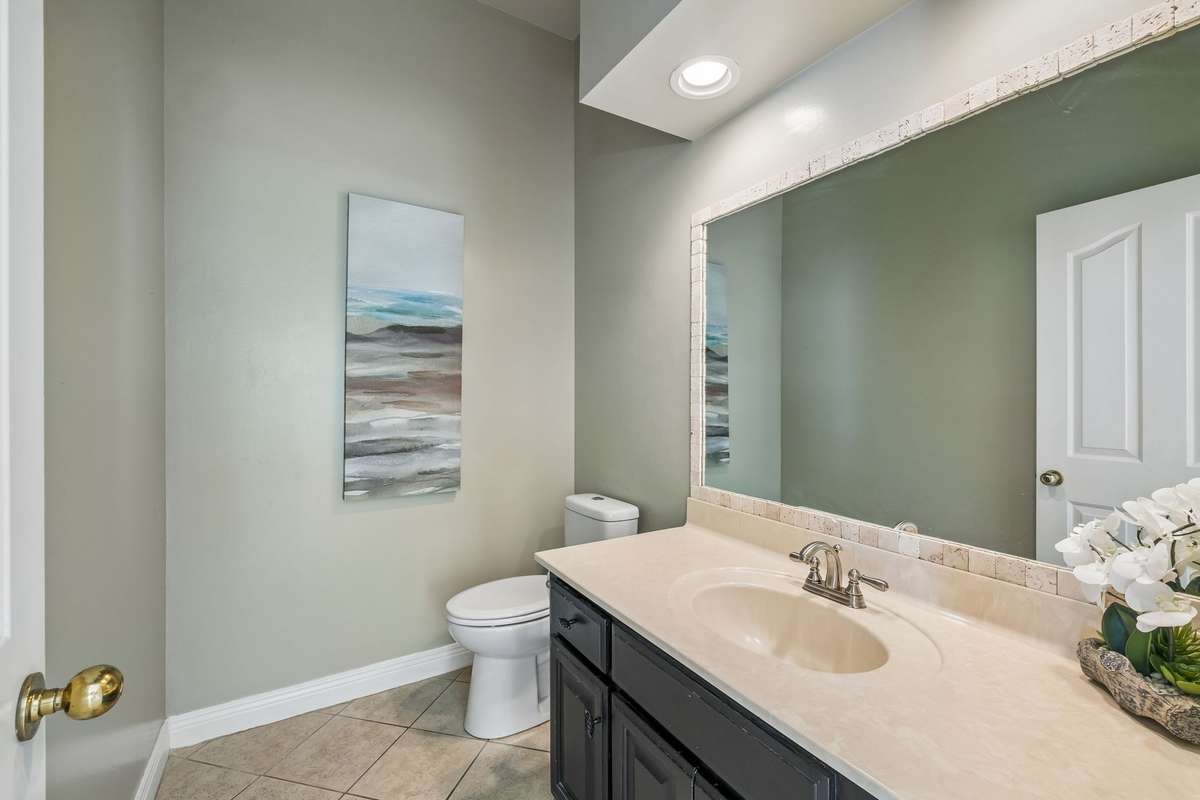The powder room is conveniently located between the kitchen and main level bonus room.