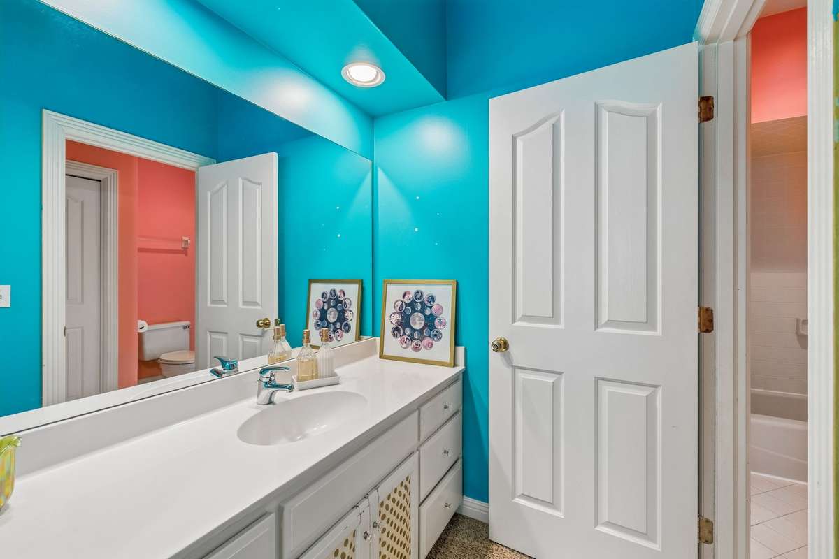 The jack and jill bathroom features two separate vanity areas.  There is a walk in closet off of this side of the bathroom that extends to a huge attic space, offering wonderful storage or the opportunity to add additional living space.