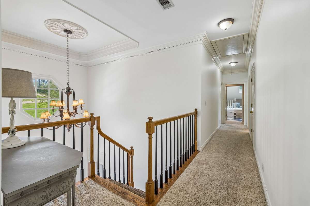 The upper level has three additional bedrooms, two baths ~ one being a jack and jill, a walk in cedar closet and a charming playroom or secondary bonus room space.