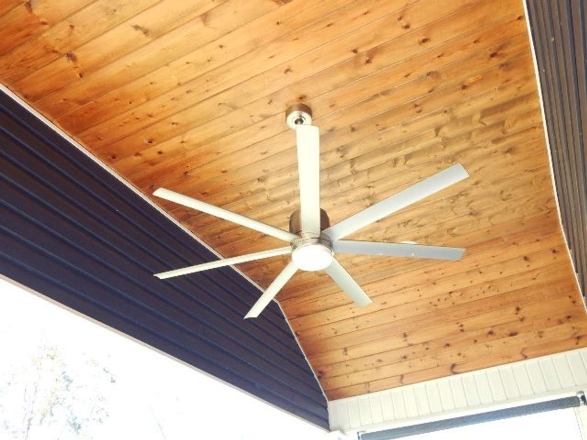 This beautifully constructed back porch ceiling with fan is an inviting respite on those lazy afternoons