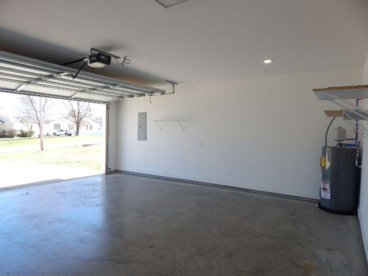 Large 2 car garage measures 21 x 23. It has a pull down ladder for attic access.