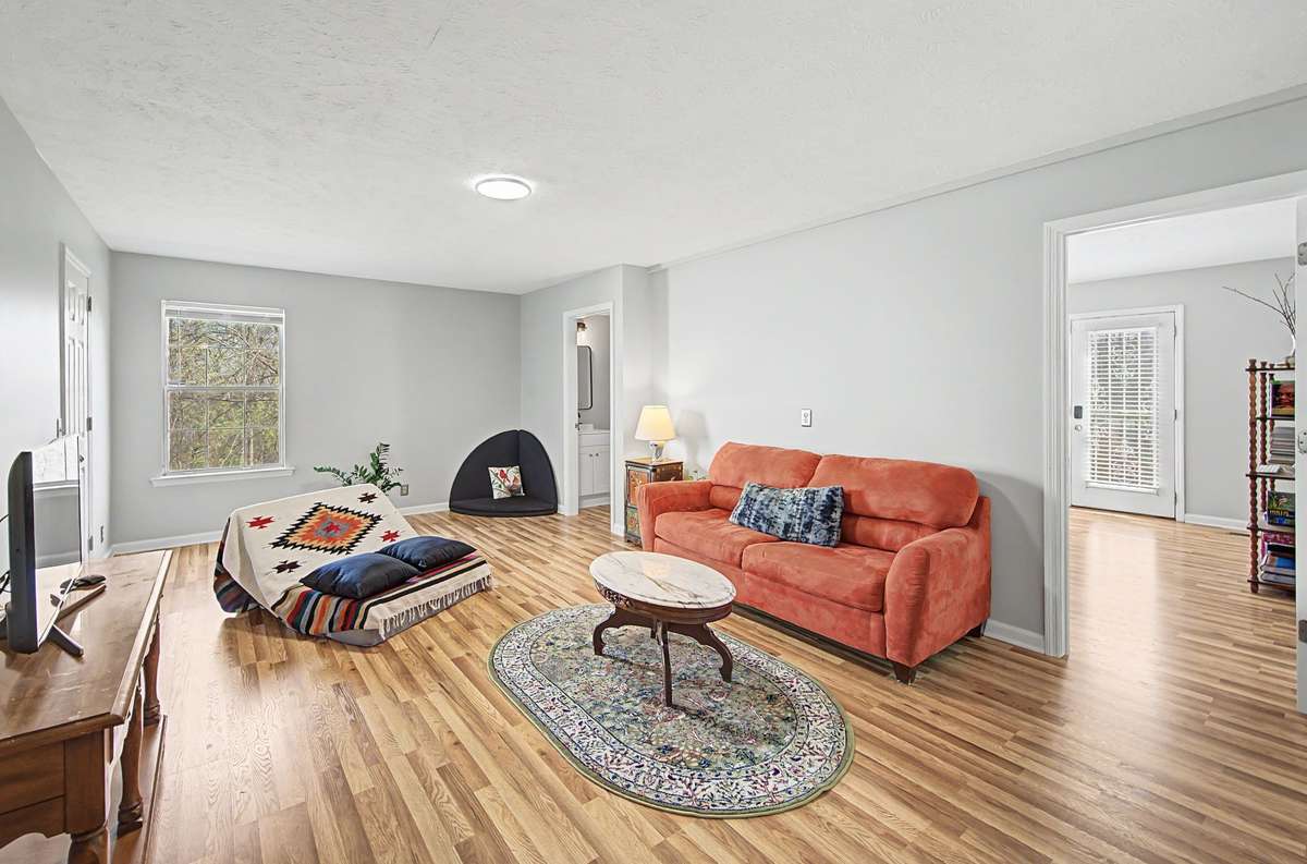 Huge rec room has hardwood floors.