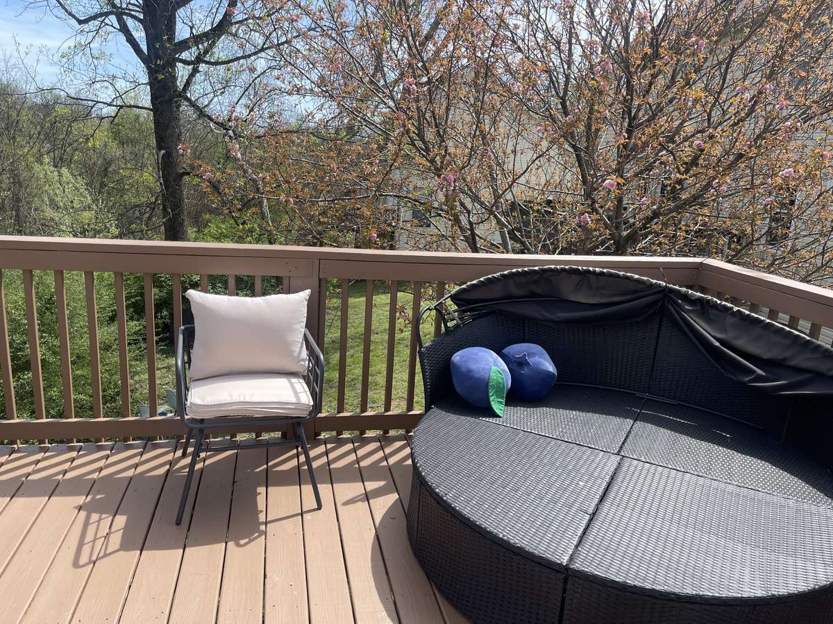 Views from the deck are of the private tree-lined backyard.
