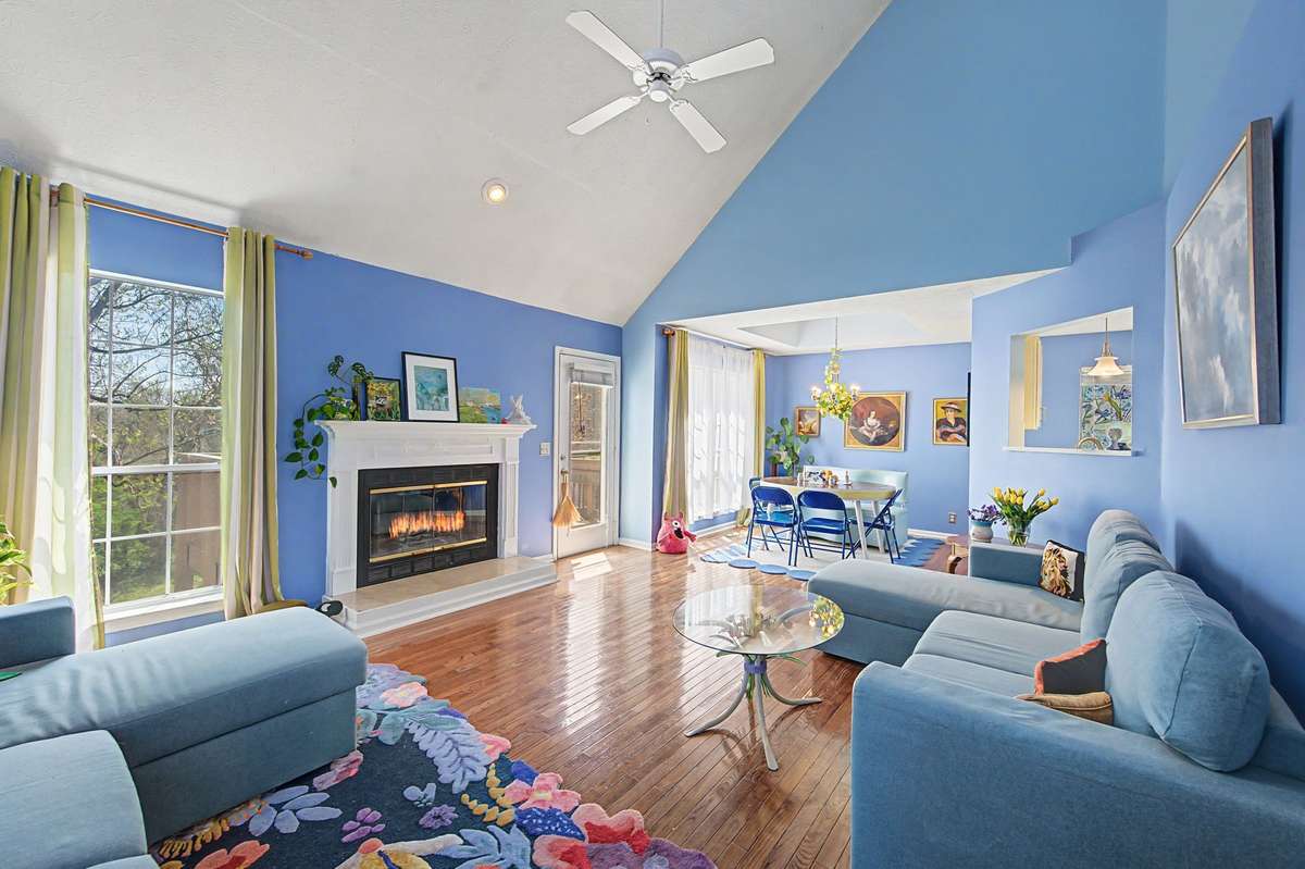 Cozy retreat defines the great room with a fireplace and vaulted ceiling and hardwoods.